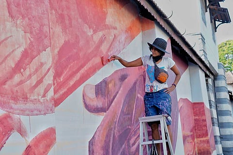 Artist Anpu Varkey working on graffiti 