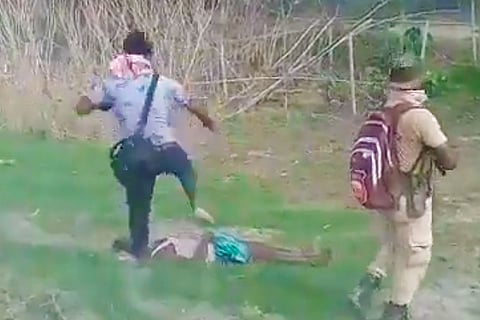 Cameraman Bijoy Bonia stomping on the body of a protester after police firing in Sipajhar in Assam 