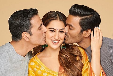 Actor Sara Ali Khan is seen alongside actor Dhanush on the right and Akshay Kumar on the left.