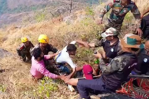 Authorities rescuing Babu from the hill