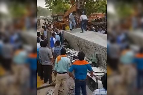 Screenshot of the video in which several people are trying to rescue those trapped beneath the concrete