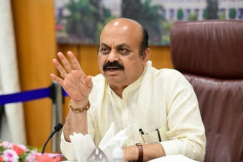 Basavaraj Bommai holding up right hand