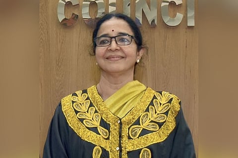 Kozhikode Mayor Beena Philip in a gold and black dress