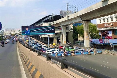 Commuters standing near Hyderabad's Begumpet Barricade