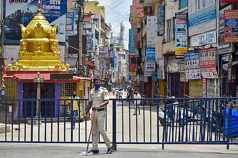 A police official during a lockdown in Bengaluru's city market 