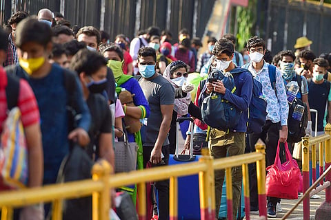 Passengers at a railway during lockdown