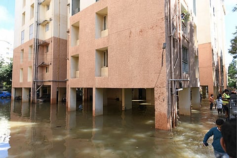 Water enters a building premises after heavy rains in Bengaluru's Yelahanka