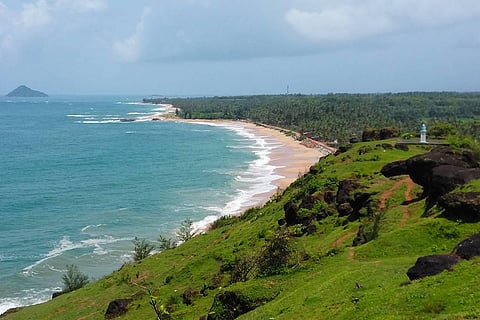 The blue sea meeting the lush green shore at Bhatkal in Karnataka
