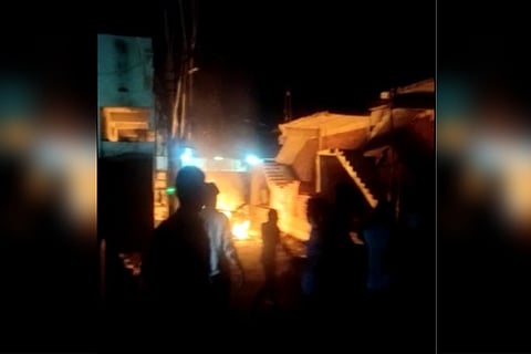 A group of men overlooking fire