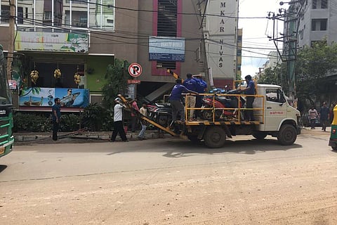 Two wheelers being towed by a tow truck