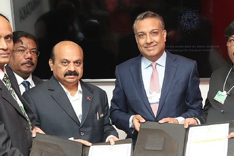 Karnataka CM Bommai and team ReNew Power, helmed by founder Sumant Sinha, holding up the MoU at Davos