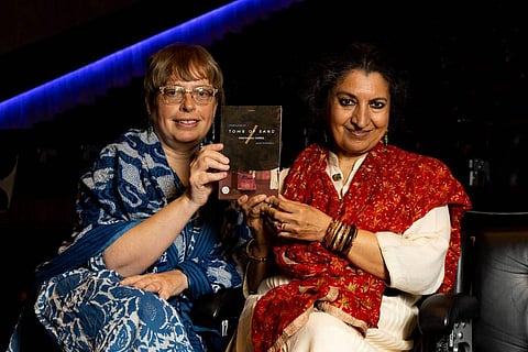 Geetanjali Shree and translator Daisy Rockwell holding up a copy of the book