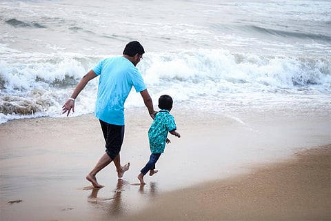 Father and child on beach