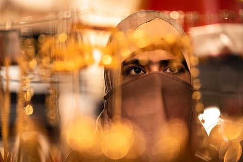 A woman in a hijab and niqab, her eyes visible 