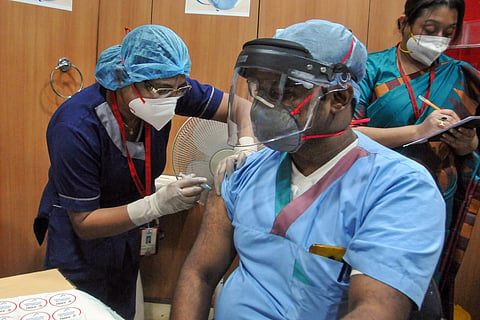 Health worker getting COVID-19 vaccine