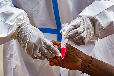A health worker collects sample for COVD-19 test