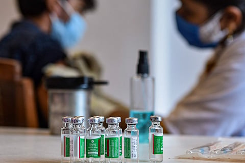 COVID-19 Vaccine: A medical worker administers a dose of COVID-19 vaccine to a man at a vaccination centre in Lucknow,