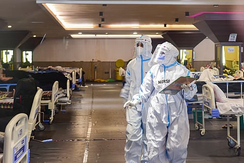Medics inspecting patients at a COVID isolation ward