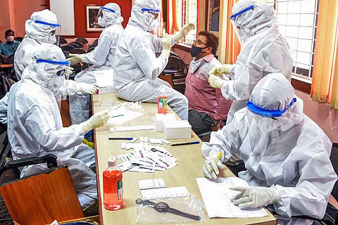 Health workers collecting samples from people