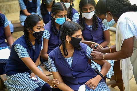 A health worker administers the COVID vaccine to students aged between 15 and 18 in Tamil Nadu