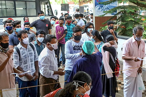  People wait to undergo COVID-19 tests as coronavirus cases surge in Kozhikode.