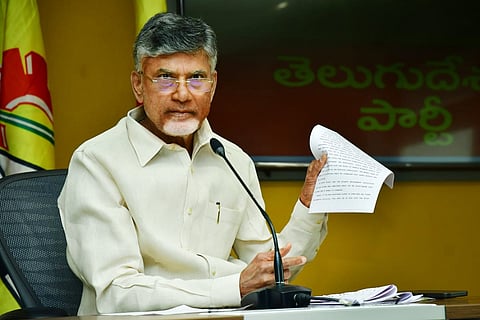Chandrababu Naidu addressing a gathering and holding up a document in one hand