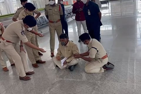 Chandrababu staging a sit-in protest as police officers gathered around him plead against it