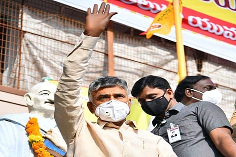 Andhra Opposition leader Chandrababu Naidu waving his hand 