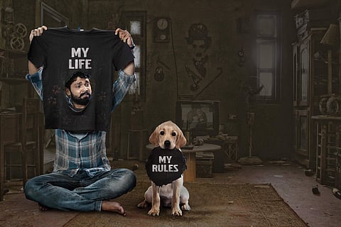 Rakshit Shetty is seen with a Labrador.
