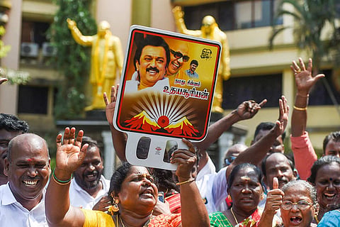 People holding posters of DMK chief MK Stalin after the party's victory in Tamil Nadu