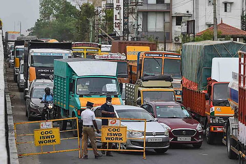 Traffic police block vehicles on a Chennai road