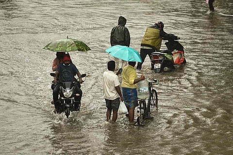 People walking on flooded road 
