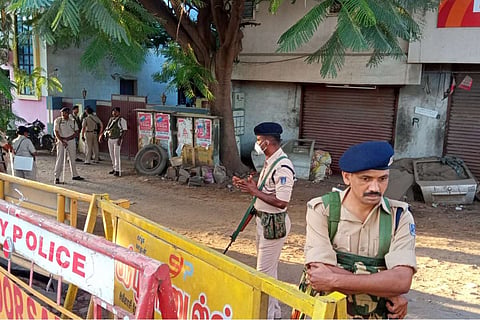 Policemen with guns on an empty street