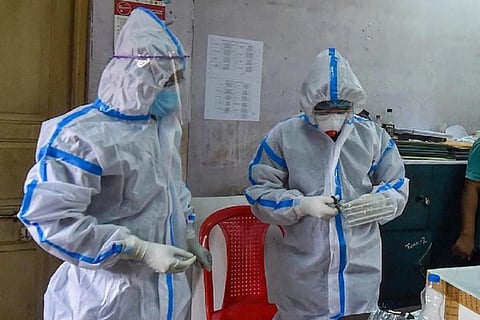 Healthcare workers in hospital wearing PPE kit
