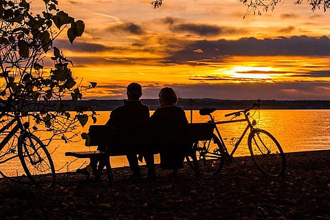 Couple sitting by a lake