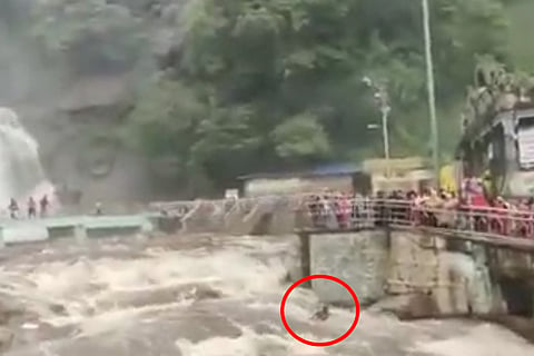 A person being washed away in Courtallam