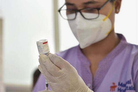 A health worker prepares to administer a dose of the 'Covaxin' vaccine at a private hospital in Bengaluru