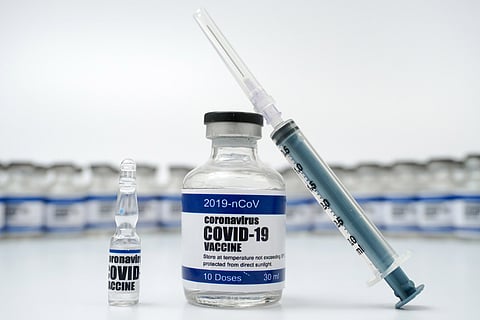 vial with COVID-19 vaccine written on it