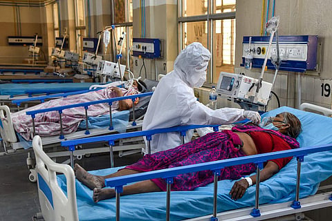 A health worker wearing PPE attends to patients at a ICU COVID Ward with Oxygen and Ventilator facilities in Hyderabad