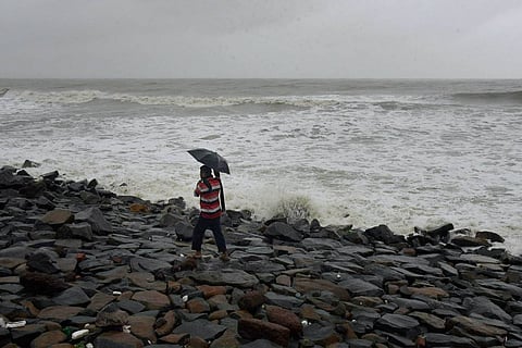 A man walking on the beach during Cyclone Amphan in 2020, IMD has said a cyclonic storm likely to reach Andhra, Odisha coasts on Dec 4