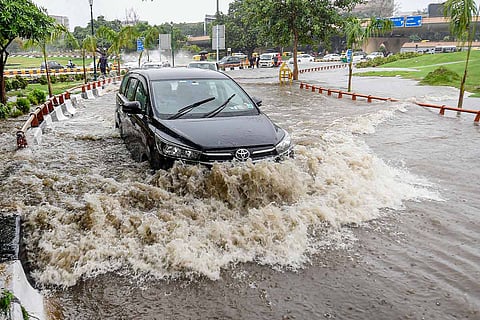 File image of a car travelling through a waterlogged road