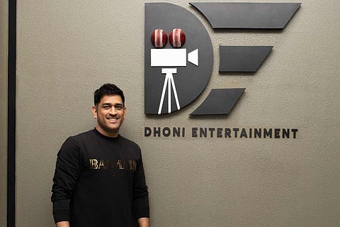 MS Dhoni with his production banner in the background