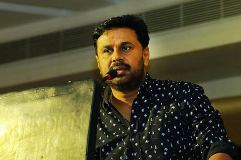 Dileep before a microphone