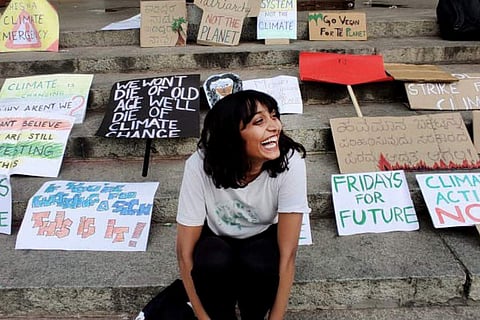 22-year-old Bengaluru climate activist Disha Ravi surrounded by placards with various slogans