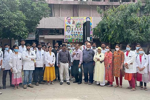 Doctors wearing black badges and protesting