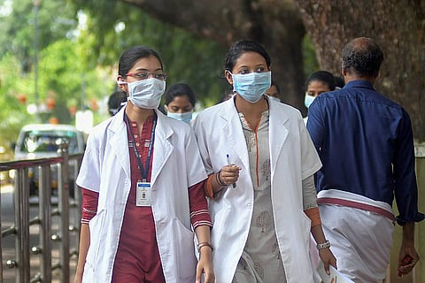 Two doctors walking on the road in Kozhikode: Why Indian students go abroad for MBBS: The inadequacy of opportunities at home