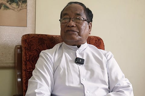 Archbishop of Imphal Domnic Lumon sits in a chair 