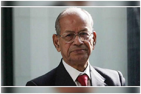 Kerala Metroman E Sreedharan wearing a coat and tie smiling looking into camera 