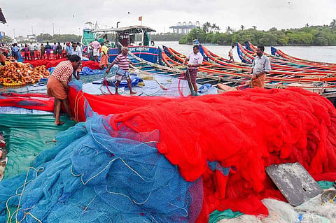 Fishermen tending to fishing nets