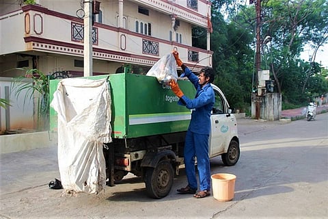 A file photo of a GHMC worker collecting garbage from households